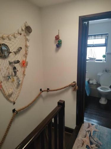 a room with a stairway with a towel on the wall at Fishermen's cottage with log burner, 2 bathrooms & sea views from garden terraces in The Mumbles