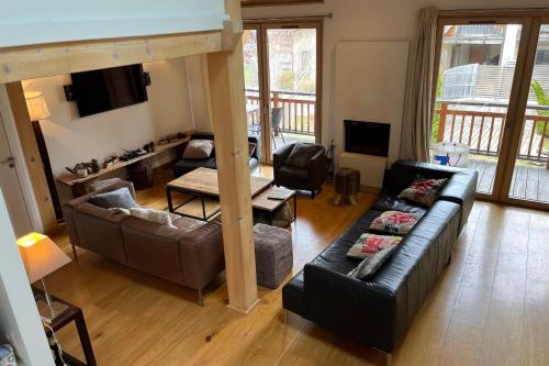 a living room with two couches and a television at Chalet Of 235 M2 With Balcony Garden In Chamonix in Chamonix