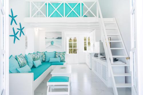 a room with a blue couch and a bunk bed at Oia Sunset Villas in Oia