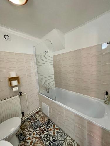 a bathroom with a tub and a toilet and a sink at Dorfel in Košice