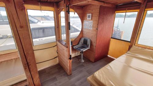 um pequeno quarto com uma cadeira num barco em Wasserlinie em Neuruppin