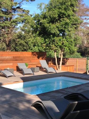 a swimming pool with lounge chairs next to at Chambre à Louer sur bonifacio in Bonifacio