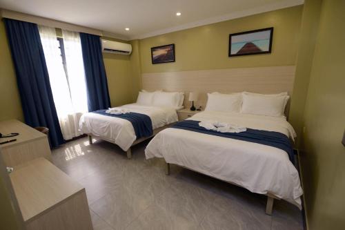 Voodi või voodid majutusasutuse The Caye Hotel toas
