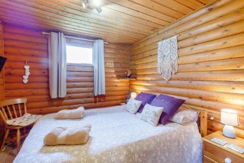 a bedroom with a bed in a log cabin at Harbottle Lodge in Longframlington