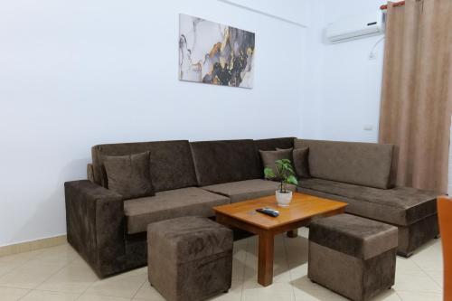 a living room with a couch and a table at Ernest Apartments in Sarandë