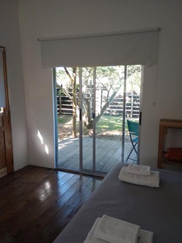 Habitación con cama y puerta corredera de cristal en je nous studio 3 en José Ignacio