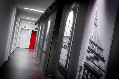 a hallway with pictures of the eiffel tower on the wall at TURINHOMETOWN Residence Apartments in Turin
