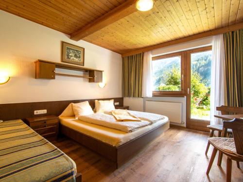 a hotel room with a bed and a window at Ferienhaus Oblasser II in Finkenberg