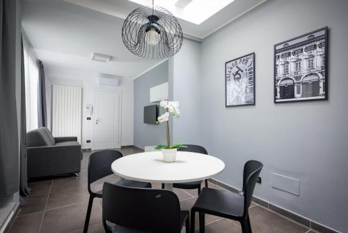 a living room with a white table and chairs at TURINHOMETOWN Residence Apartments in Turin