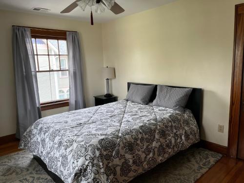 a bedroom with a bed and a ceiling fan at Historic Downtown Brownsburg Home w/Charm in Brownsburg