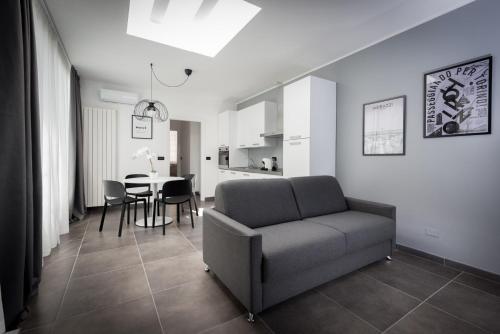 a living room with a couch and a table at TURINHOMETOWN Residence Apartments in Turin