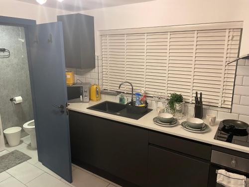 a kitchen with a sink and a counter top at Lovely studio apartment located in Birmingham in Birmingham