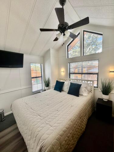 a bedroom with a large bed with a ceiling fan at Sun & Snow Chalet Breckenridge, a dog lovers dream! in Breckenridge
