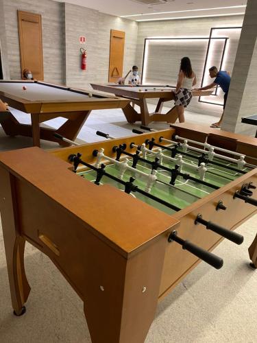 a group of people playing a game of billiard at Flat em Salinópolis no Salinas Premium Resort in Salinópolis