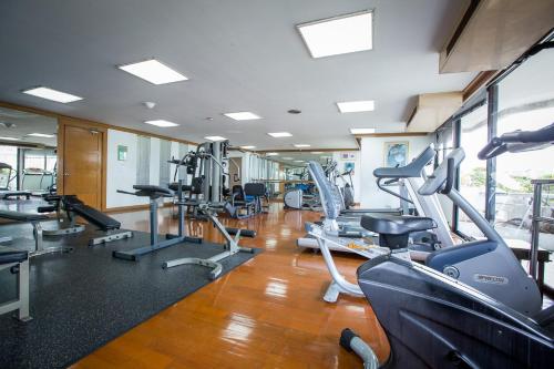 a gym with several treadmills and cardio machines at Trinity Silom Hotel in Bangkok