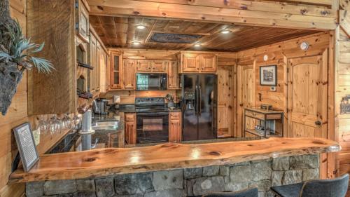 a kitchen with wooden cabinets and a large counter top at Aska Pines in Blue Ridge