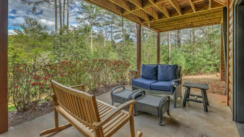 a porch with a rocking chair and a table at Aska Pines in Blue Ridge