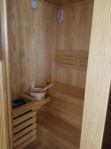 a sauna with a toilet in a wooden room at Khách sạn Hưng Việt (Măng Đen) in Kon Tum