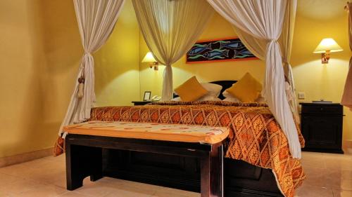 Postel nebo postele na pokoji v ubytování Masainn Hotel Kuta