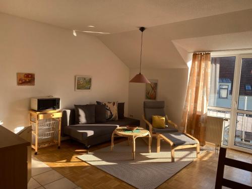 a living room with a couch and a table at Ferienresidenz Am weißen Regen in Bad Koetzting