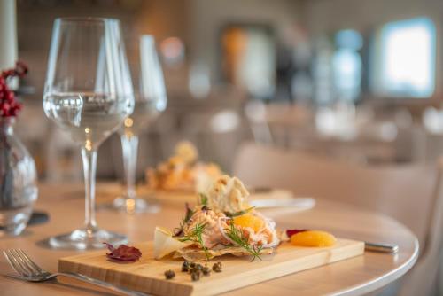 a plate of food on a table with a glass of wine at Lapland View Lodge in Övertorneå