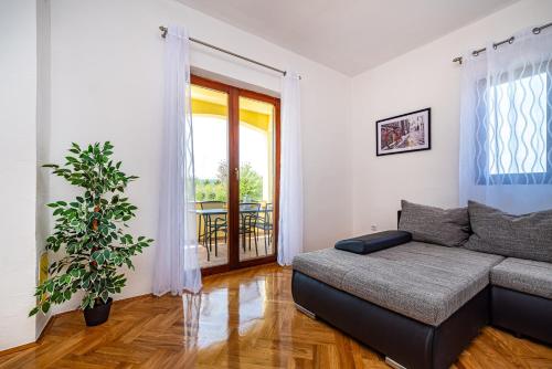 a living room with a couch and a window at Apartment Marija in Novigrad Dalmatia