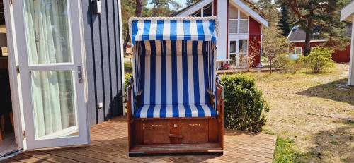 a rocking chair sitting on the porch of a house at Villa Mar Baabe in Baabe