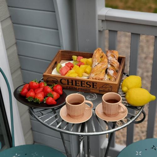 a table with a box of bread and two cups of coffee at The Cozy Cub in Romsey