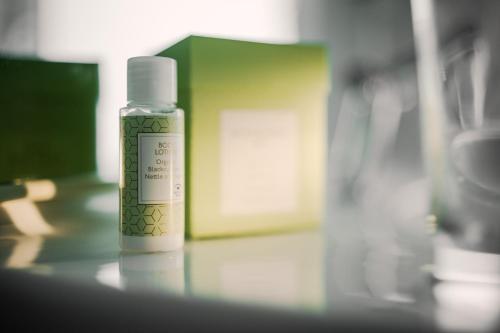 a bottle of moisturizing cream sitting on a table at Romantik Hotel Neuhaus in Iserlohn