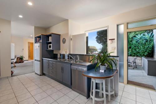 a large kitchen with a sink and a counter at APARTMENT 4A - By the Beach in Paraparaumu Beach