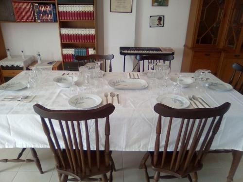 a table with a white table cloth and glasses on it at VILLA S&A MEDITATION in Chalkida