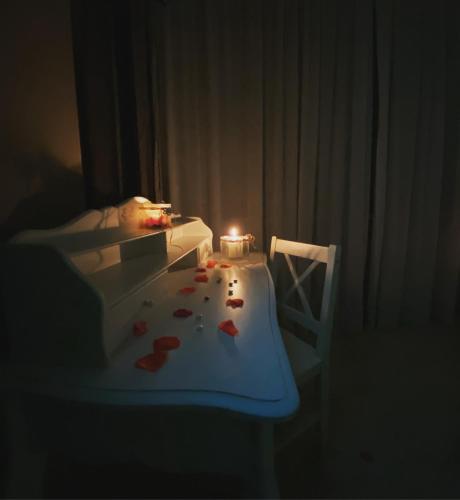 a room with a table with a candle and hearts on it at B&B incentro in Foggia
