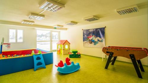 a room with a play room with a pool table and toys at Vacancéole - Appart'Vacances Pyrénées 2000 in Bolquere Pyrenees 2000