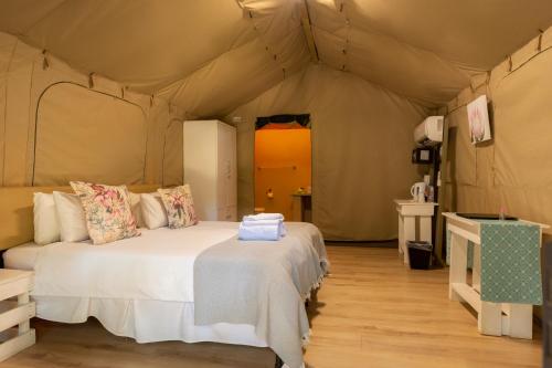 a bedroom with two beds in a tent at Lions Rock Rapids - Luxury Tented Camp in Hazyview