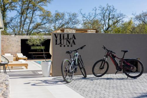 two bikes are parked next to a wall at Villa Luna in Županje