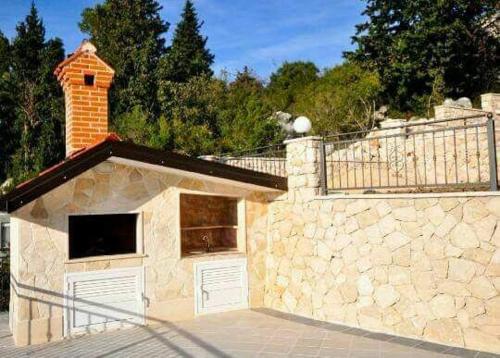 a building with a brick chimney on top of a wall at Villa Fabry in Ploče