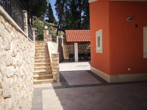 a building with a staircase and a brick wall at Villa Fabry in Ploče