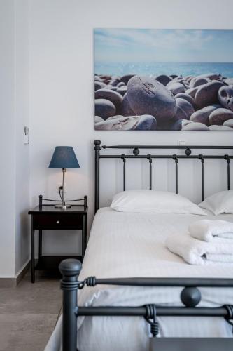 a bedroom with a bed with a picture on the wall at Milva Apartments in Kos Town