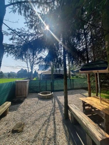 a park with benches and a tree and a playground at Domek Przekolec in Szaflary