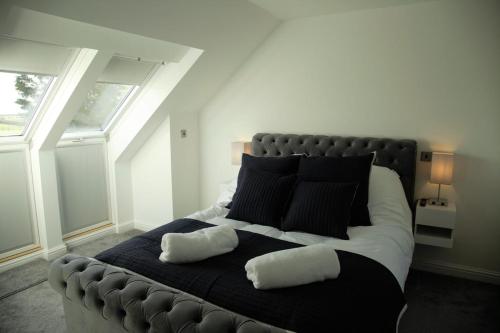 a bedroom with a large bed with two pillows on it at Southview farm in Halsham