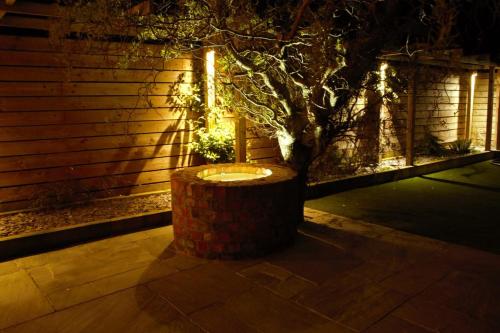 a lighted stump with a tree in front of a building at Southview farm in Halsham