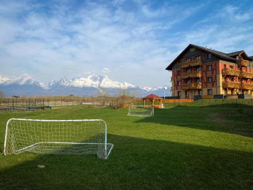 a soccer goal in a field in front of a building at Apartmán Mountain View - Tatragolf C in Veľká Lomnica