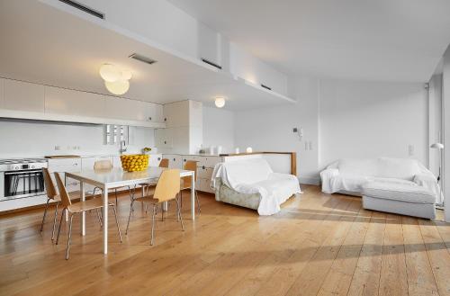 a living room with a table and a bedroom at Canvas Apartments&Lofts in Cadaqués