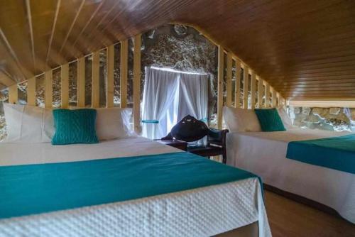 a room with two beds and a window at Quinta Vale de Frades in Torrão