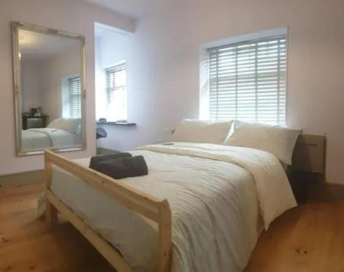 a bedroom with a large bed and a mirror at Buck - En-suite Room in Canalside Guesthouse in Burnley