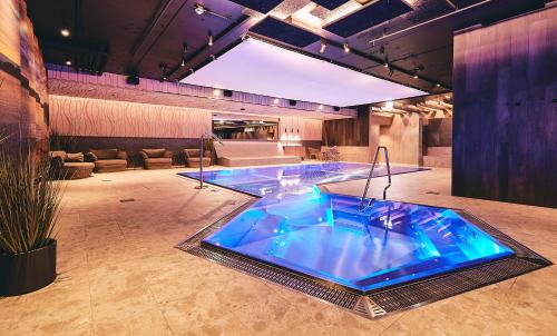 a large hot tub in a room with a couch at Stord Hotel in Stord