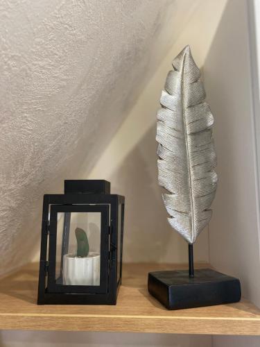 a feather statue next to a picture frame on a shelf at DivčiBor in Divčibare