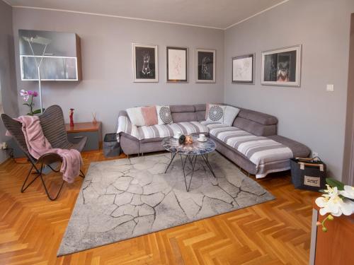 a living room with a couch and a table at Apartman Point in Pula