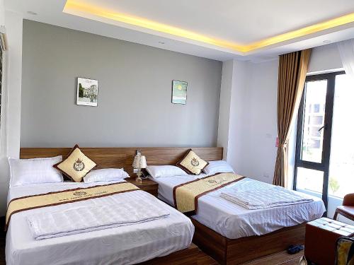 Кровать или кровати в номере Kim Minh Lux Hotel Sam Son