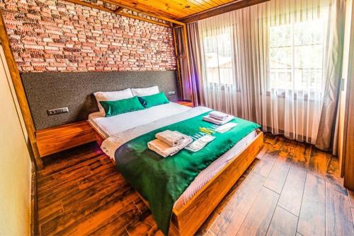 a bedroom with a bed with two towels on it at Inanlar Premium Suites & Villas in Uzungöl